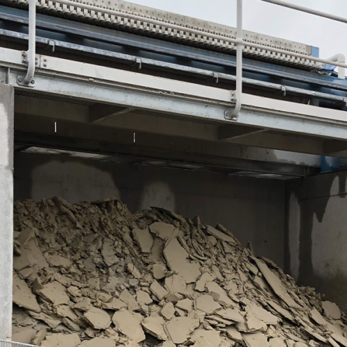 Filter cake dropping from a CakeMax® filter press at a large construction site
